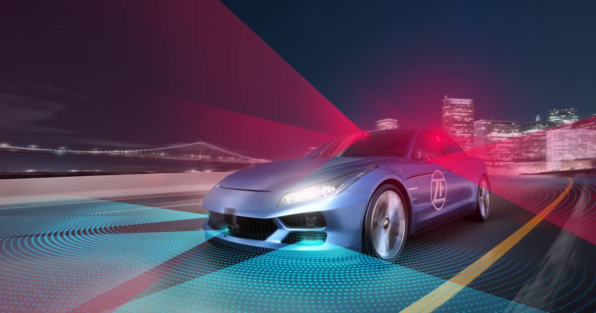 Blue Car with ZF Logo On with Red and Blue Lights Driving Past Skyscrapers