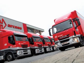 Photo of Arecese red trucks lined up in a row with one in front